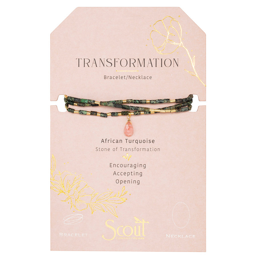 The Scout Jewelry Transformation African Turq Gold Teardrop Wrap is a bracelet/necklace with green and gold beads, a pink charm, on a "Transformation" card featuring African turquoise and floral gold accents.