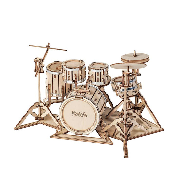 The Laser Cut Wooden Puzzle: Drum Kit by Hands Craft features an intricately detailed 3D model with components including a bass drum, snare, toms, cymbals, and a hi-hat. The precisely designed interlocking pieces create a lifelike impression of a full drum kit. The word "Rolife" is visible on the bass drum, making it an ideal piece for home decoration.