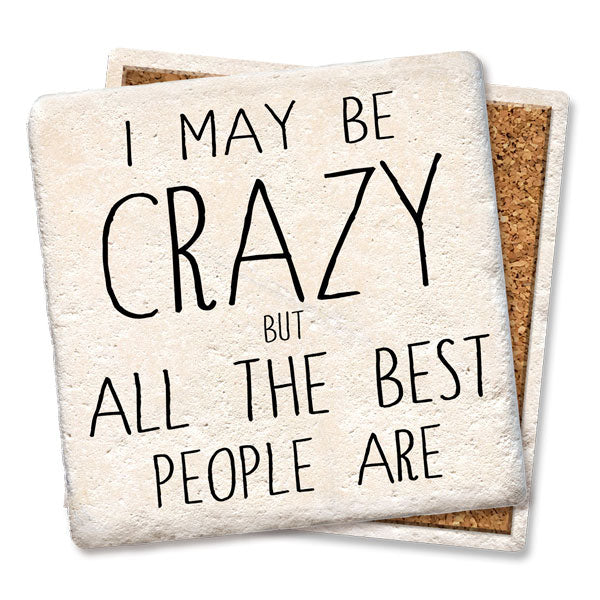 The Tipsy Coaster "I may be crazy Coaster" set includes two square natural limestone coasters with cork backing. The top coaster features black text: "I may be crazy but all the best people are." Absorbent surface protects your table.