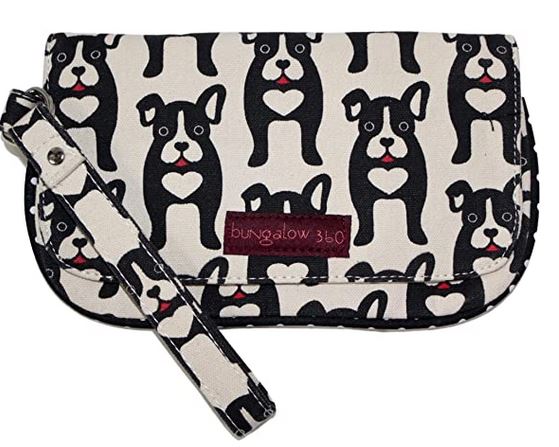 The Bungalow 360 Large Wristlet features a black and white dog print with hearts on a beige cotton canvas. This unique vegan bag has a snap closure and a maroon "Bungalow 360" label on the front.