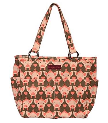 The Bungalow 360 Pocket Bag Pig is a vegan tote with two handles, cute pink pig and heart prints on brown, exterior pockets, a "bungalow 360" label, and a charming polka dot lining.