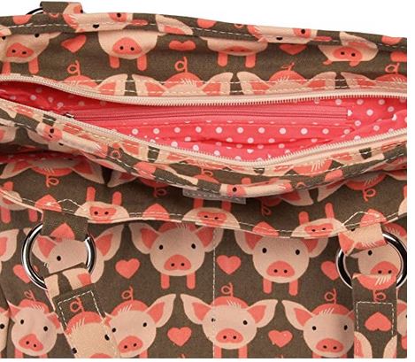 The Bungalow 360 Pocket Bag Pig is a whimsical vegan fabric handbag with a cute pig and pink heart print, open to reveal a pink polka dot lining and silver rings attaching the handles.