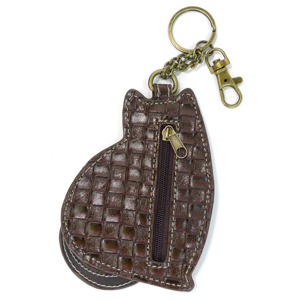 The **Cat Keychain with Zip** by **Chala** is crafted from brown leather in the shape of a cat, featuring a tiny zippered pocket on its body. It includes a metal ring and clasp with antique brass hardware, and the leather is adorned with a woven pattern for added texture.