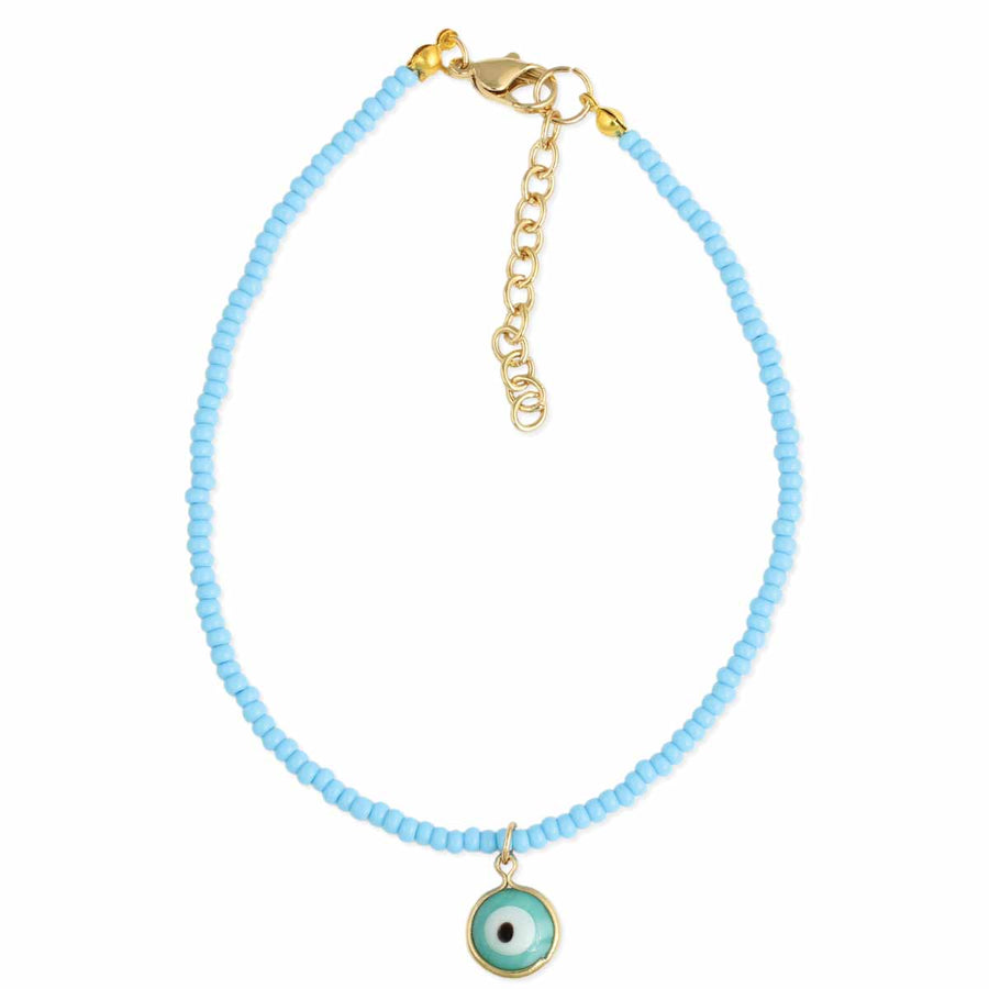 The Watchful Blue Eye Anklet by ZAD Jewelry features small light blue beads, a gold lobster clasp with adjustable chain, and a central round evil eye charm in blue, white, and black.