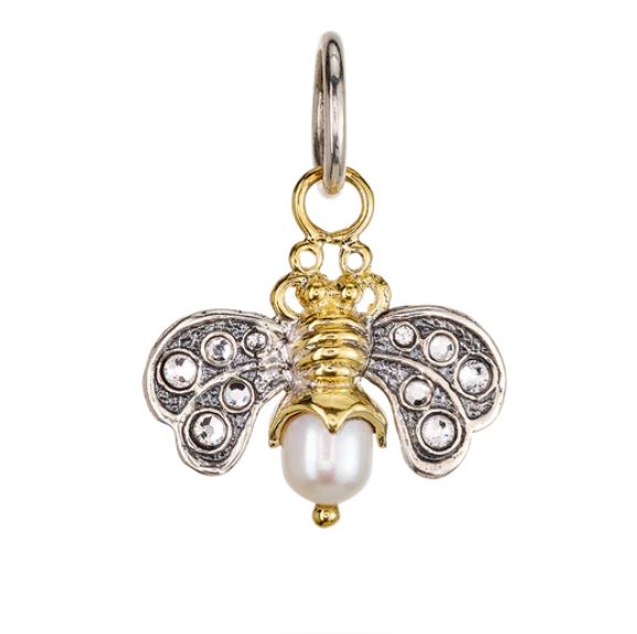 The Waxing Poetic Crystal Honeypearl Bee Charm features gold and sterling silver accents, jeweled wings, a freshwater pearl body, and attaches to a round metal loop.