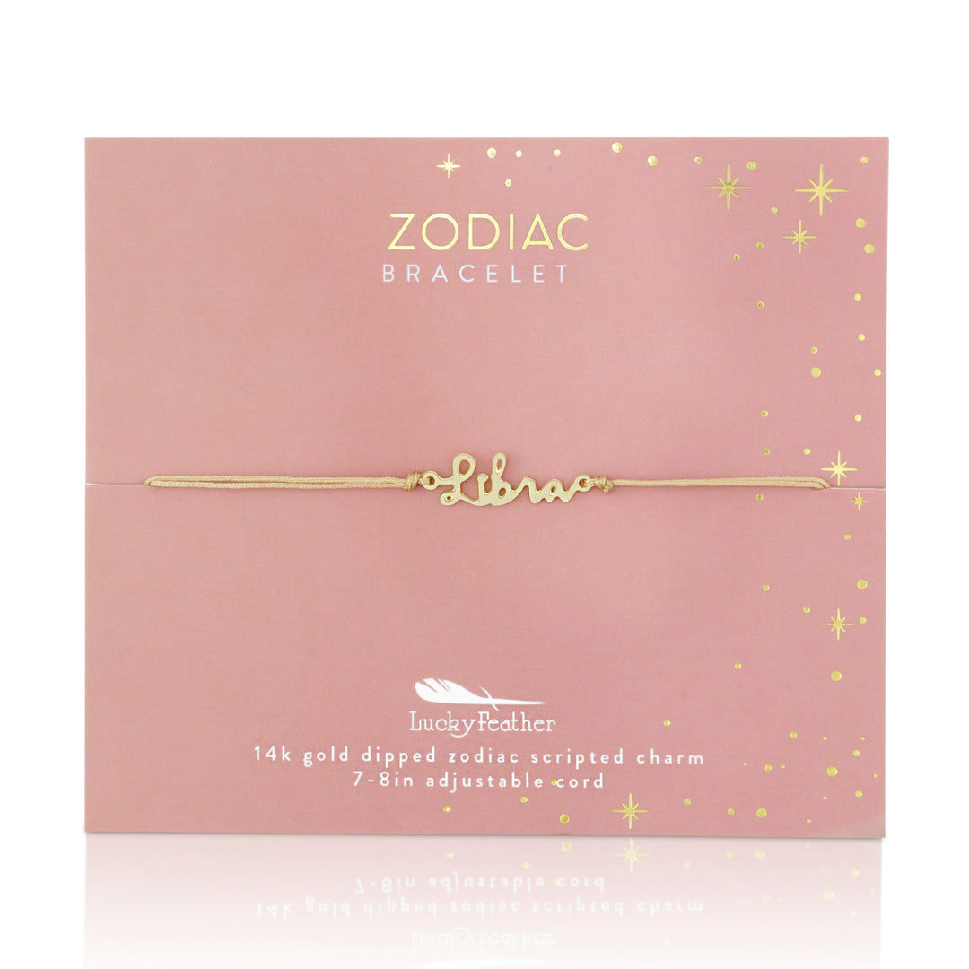 On a pink card, the "Zodiac Bracelet Libra" from LuckyFeather is showcased, featuring a gold bracelet beautifully inscribed with "Libra." Glittery star designs enhance the card, accentuating details of the 14k gold-dipped charm and adjustable cord bracelet for an ideal fit.