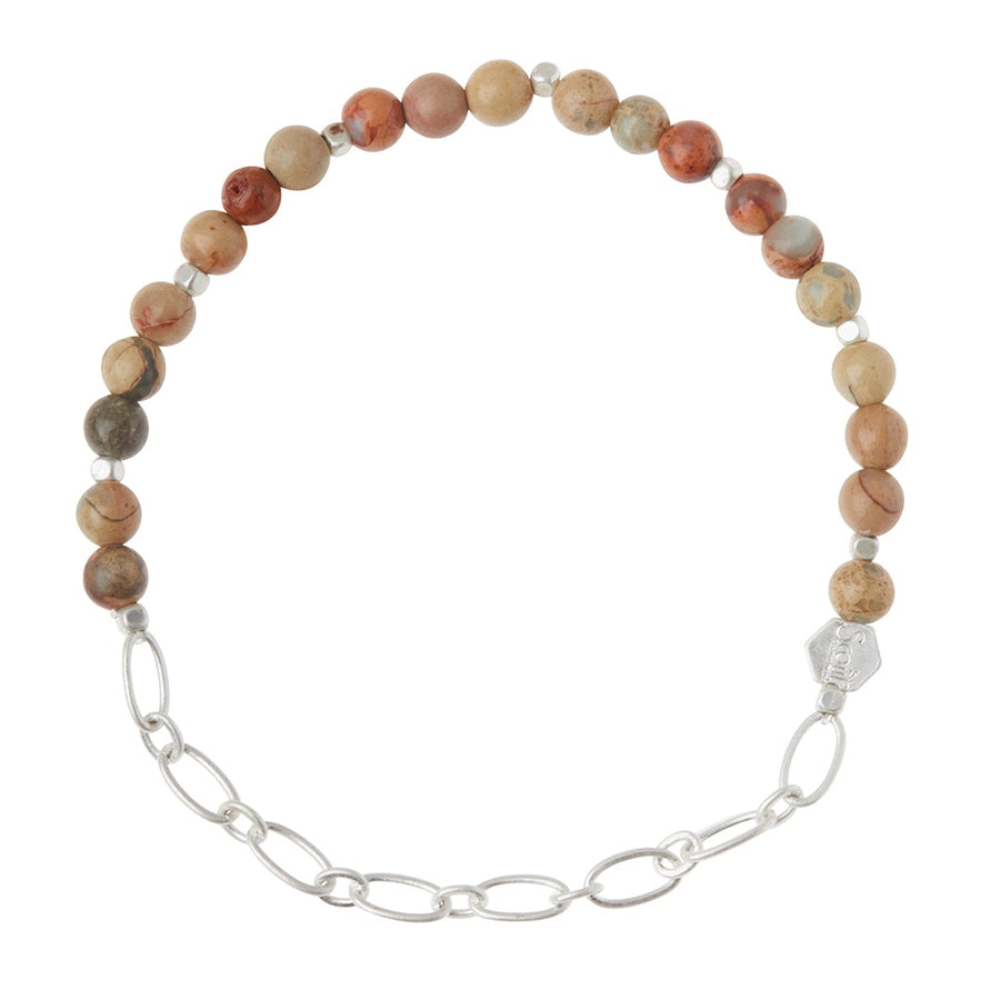 The Chain Bracelet Aqua Terra/Silver by Scout Jewelry showcases an elegant combination of round, earth-toned semi-precious gemstone beads in shades of brown, red, and gray alongside a silver paperclip chain. It is enhanced with an engraved logo bead and fastens gracefully with a silver clasp.
