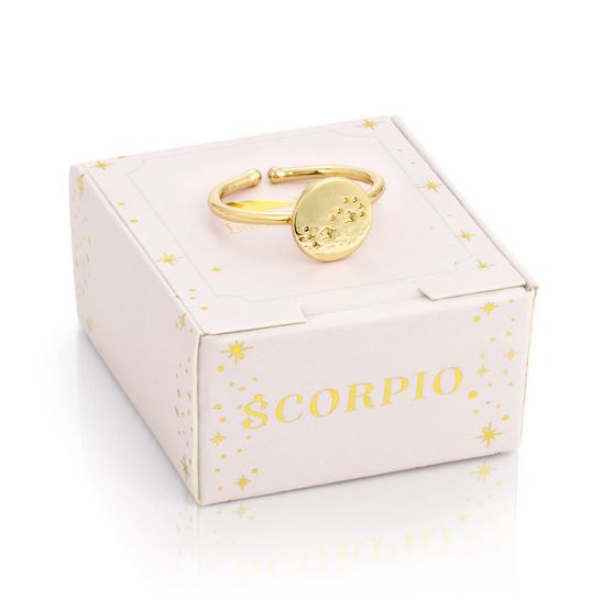 The LuckyFeather Scorpio Signet Ring, a gold-dipped adjustable band with a round Scorpio design, sits on a light pink "SCORPIO"-labeled box decorated with gold stars.