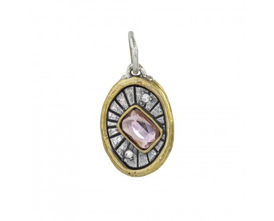 The Electric Spirit Charm by Waxing Poetic is an oval pendant with a gold brass border, central pink gemstone, two Swarovski Crystals, and a textured sterling silver background radiating with lines.