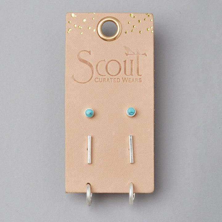The Scarlett Stud Trio Turquoise Silver by Scout Jewelry includes three hypoallergenic earring pairs—turquoise stone studs, silver bars, and silver hoops—on a beige gold-speckled card labeled "Scout Curated Wears.