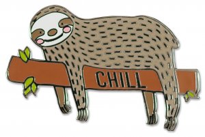 The Sloth Pin from PeterPauperP showcases a cheerful sloth relaxing on a branch adorned with vivid green leaves, alongside the word "CHILL." This charming design is ideal as a hard enamel pin, featuring a brown body with black dots, making it an adorable surprise in any gift box.